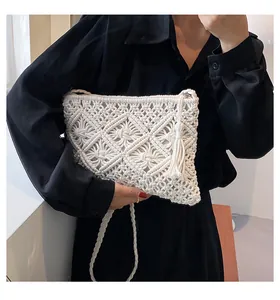 Close-up detail of white Macrame woven beach bag with handmade fringe and hollow patterns