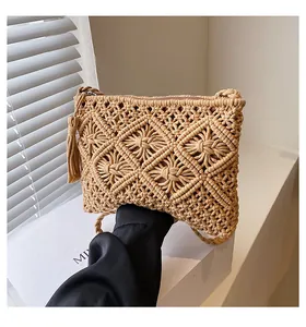 Close-up of woven bohemian bag with intricate diamond texture and side tassel details