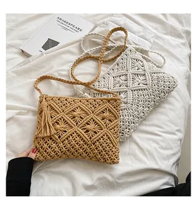 Detail of bohemian macrame crossbody bag featuring geometric patterns and fringe accents