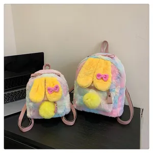 Close-up of plush rabbit backpacks in rainbow gradient with cute yellow bunny ears