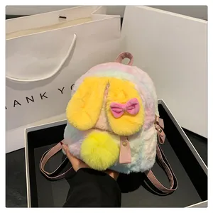 Detailed macro view of colorful tie-dye plush mini backpack with rabbit ears and pink straps