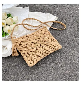 Close-up of woven crossbody bag with hollow diamond pattern and stylish fringe detail