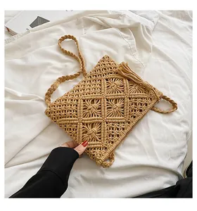 Close-up of bohemian woven shoulder bag featuring fringe detail and geometric patterns