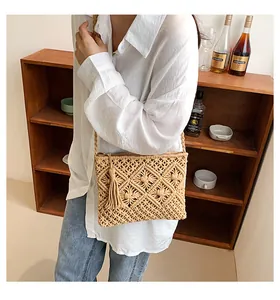 Detail of woven bohemian bag featuring fringe tassels and diamond knit pattern