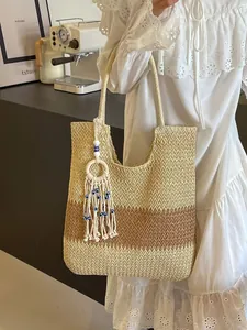 Bohemian woven straw tote bag with color blocking design and evil eye tassel charm