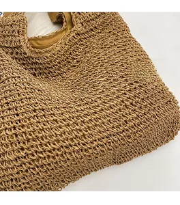 Close-up of the delicate hollow mesh weave and soft camel-toned straw fabric
