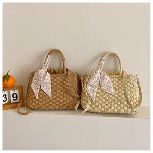 Detalle de bolsos de paja tejida en marrón y beige con pañuelo floral y forro de cordón