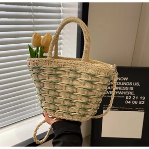 Detail of woven straw tote bag with dual-tone texture and detachable shoulder strap