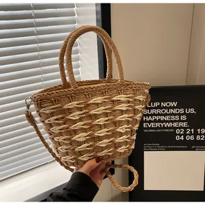 Close-up of dual-tone straw tote bag featuring wavy woven texture and metal clasps
