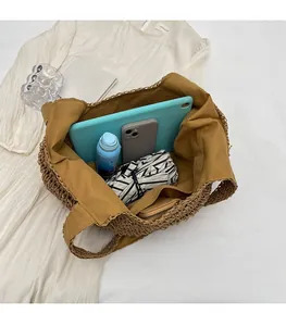 Detail view of a spacious straw tote bag showing large capacity for tablet and essentials