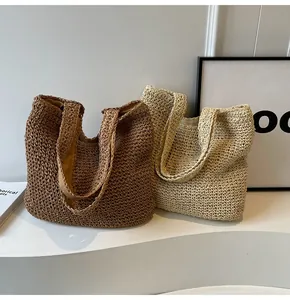 Detail of hand-woven straw tote bags in beige and brown with hollow mesh texture