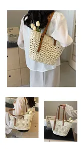 Detail view of woven straw tote bag with brown leather handles and hollow knit texture