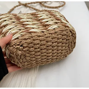 Detailed close-up of woven texture on dual-tone beige and brown straw shoulder bag