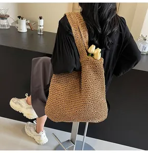 Detail of hand-woven straw tote bag with tulips showing large capacity and texture