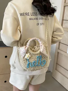 Handwoven straw shoulder bag with hello embroidery and floral scarf wrapped handle