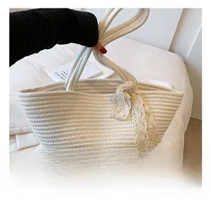 Close-up of hand-woven cotton rope tote bag featuring delicate lace ribbon and rustic texture