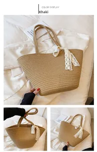 Detail of khaki woven straw tote bag featuring a cream lace bow accent for summer vacations