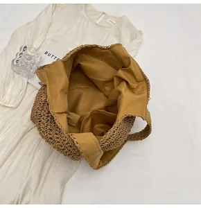 Detailed view of handmade woven straw tote bag with fabric lining and inner pocket