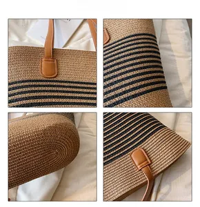 Detail view of woven straw tote showing PU leather handles and fine stitching quality