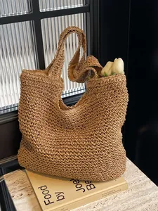 Handmade woven straw tote bag with flowers in a minimalist aesthetic window setting