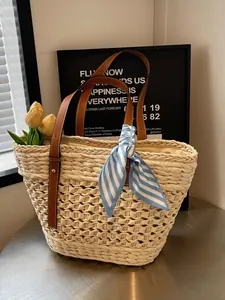 French style straw woven tote bag with brown leather handles and striped silk scarf decor