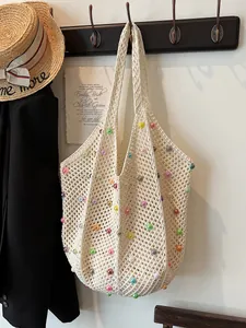 Beige crochet beach tote bag with colorful beads for summer vacation beach look