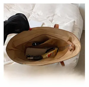 Top view of spacious brown tote bag interior with multiple pockets and zipper closure