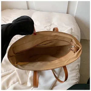 Interior view of large straw beach tote bag with fabric lining and zipper pocket