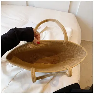 Top view of woven straw beach bag with spacious interior and spiral weave details