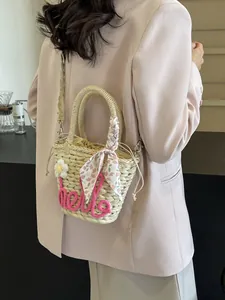 Chic woven straw handbag with pink 'hello' lettering and floral scarf for beach vacation