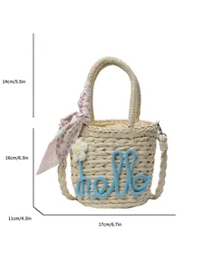 Handwoven straw tote bag with blue 'hello' script and floral silk scarf for summer beach
