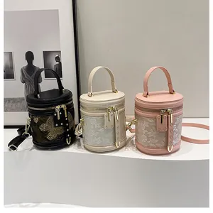 Three elegant cylindrical bucket bags with lace embroidery shown in black white and pink