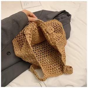 Detail of hollow-out straw tote bag showing large capacity and artisanal hand-woven texture