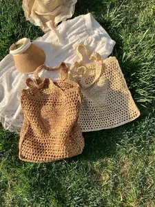 Large hollow straw tote bag in khaki and off-white colors for summer beach vacations