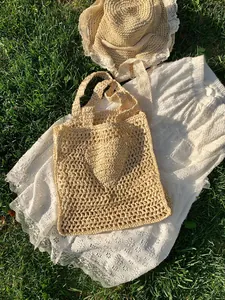 Fashionable summer straw woven tote bag with heart pattern and matching lace trim sun hat