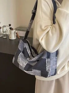 Vintage patchwork denim shoulder bag featuring a checkerboard design and adjustable strap