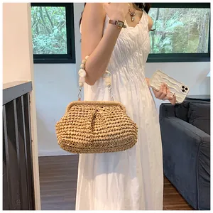 Detail of woven straw bag texture with elegant resin bead handle on white dress