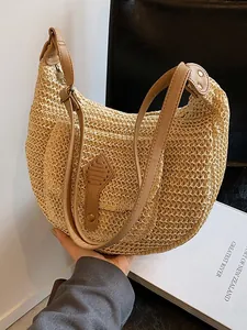 Straw crescent shoulder bag with brown leather strap for summer beach vacations