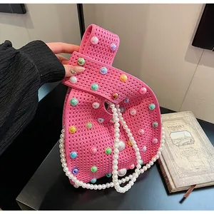 Details der rosa Stricktasche mit bunten Perlen und weißem Perlenriemen im Nahaufnahme