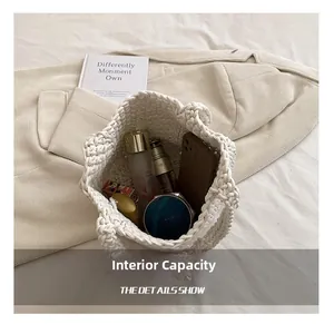 Top view of white woven bucket bag showing internal capacity for phone and cosmetics