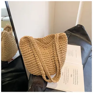 Detailed view of the thick woven texture and sturdy handle on a khaki beach tote bag