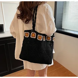 Close-up of bohemian crochet tote bag featuring sunflower knits and black mesh texture