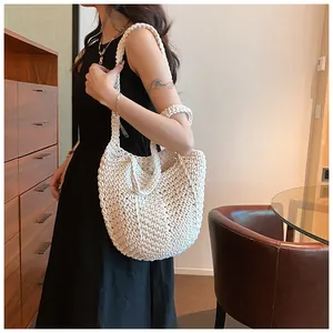 Close-up of a white hand-woven bucket bag showing its thick cotton rope texture