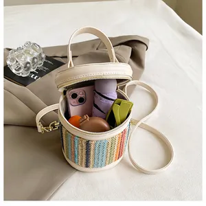 Top view of rainbow woven bucket bag showing storage for phone, umbrella and sunglasses