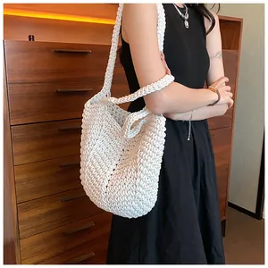 Detailed macro view of the white handmade woven shoulder bag with intricate textured knitting