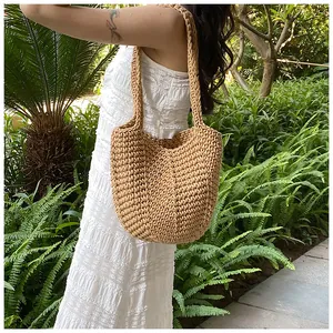 Detailed close-up of bohemian hand-woven straw tote bag with coarse crochet texture