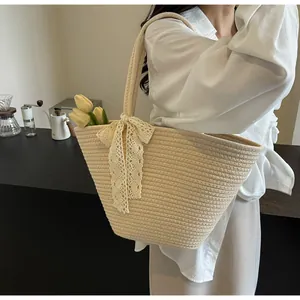 Detailed macro view of woven tote bag with delicate lace bow and natural cream texture