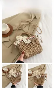 Detailed view of hand-woven straw bucket bag with lace bow and floral decorations