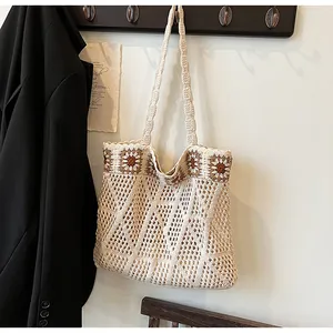 Detail of hand-woven crochet tote bag with daisy floral pattern and knit texture