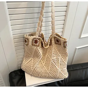 Detail of hand-woven tote bag showing hollow-out knit texture and brown floral crochet patterns